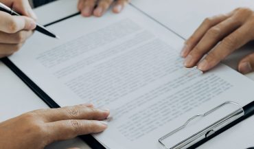 Couple is divorced who handed their engagement ring to the divorce documents that the lawyer was clarifying.
